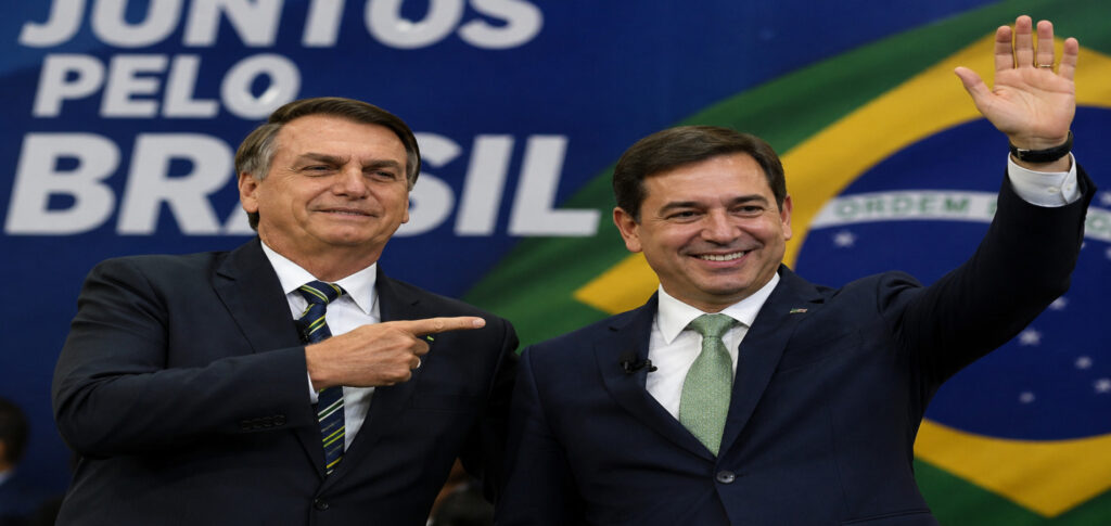 Brazilian presidential candidate Jair Bolsonaro stands beside his newly announced running mate during a campaign event