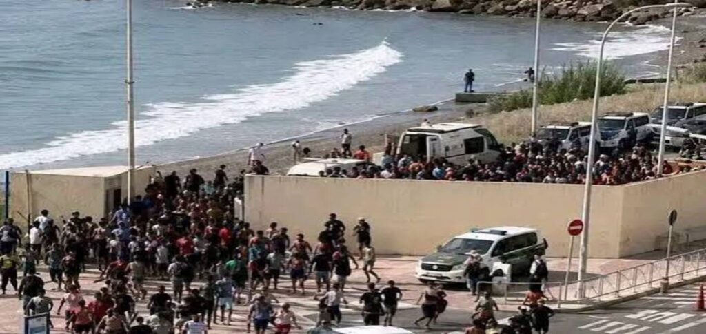 Ceuta migrant deal as Spanish Civil Guard officers monitor migrants arriving on the coast after Spain and Morocco agreed faster return procedures